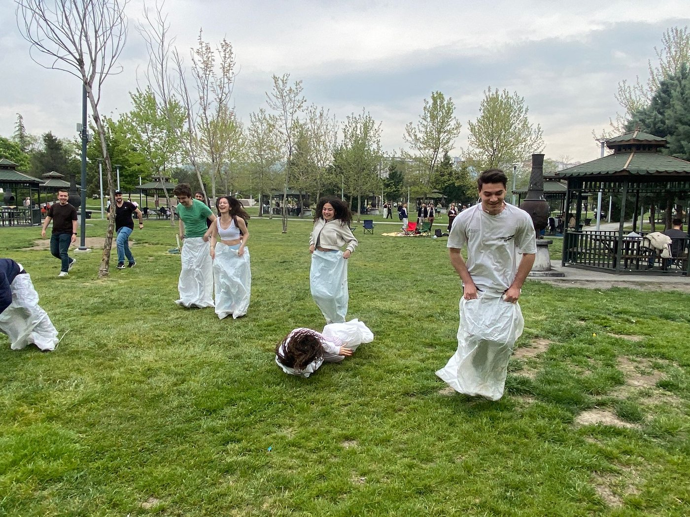 Students participating in the sack race experience fun and competitive moments during the event.
