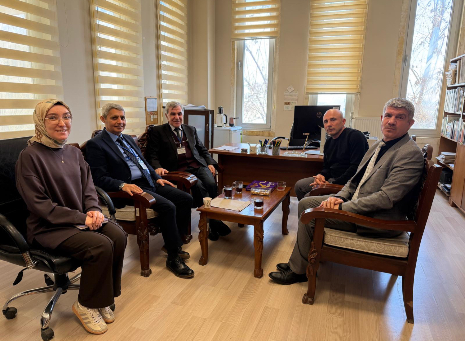 Our faculty member and the other evaluation team members in the meeting room.