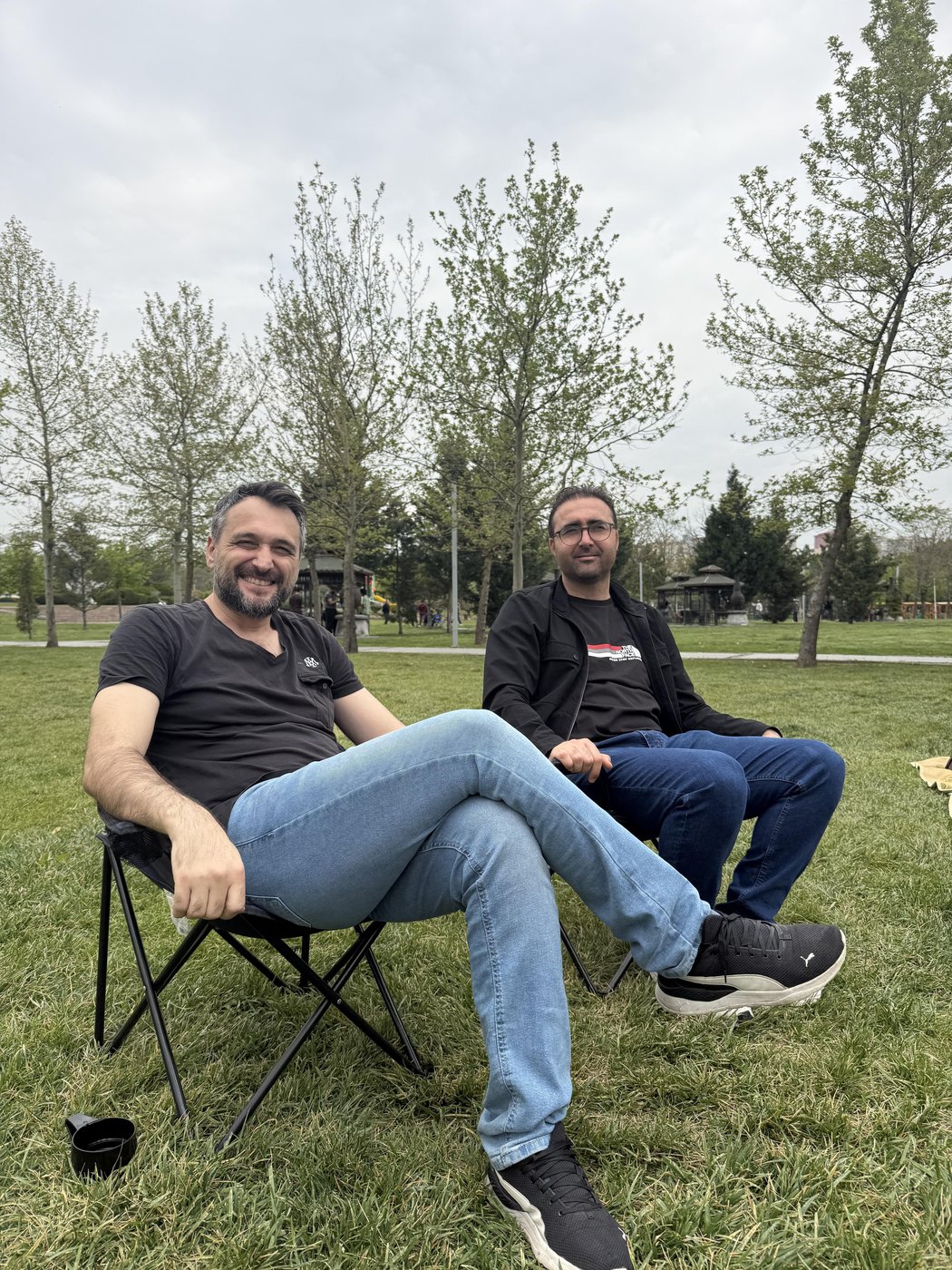 Assoc. Prof. Dr. Yenal Arslan and Assist. Prof. Dr. Mehmet Ulvi Şimşek are seen sitting side by side in the picnic area.
