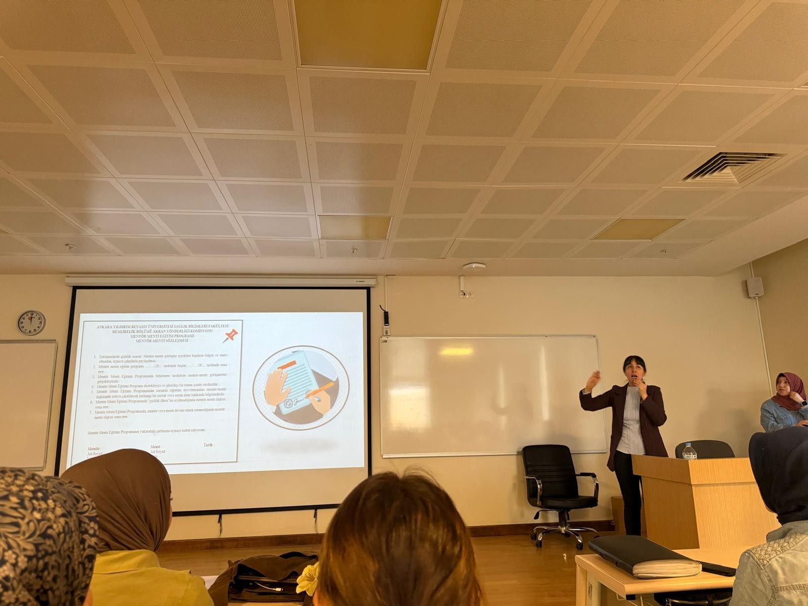 Associate Professor Reyhan Eskiyurt and Research Assistant Şeyma ALBAKIR introducing the forms to be used as part of the Mentor–Mentee Program to third-year students.