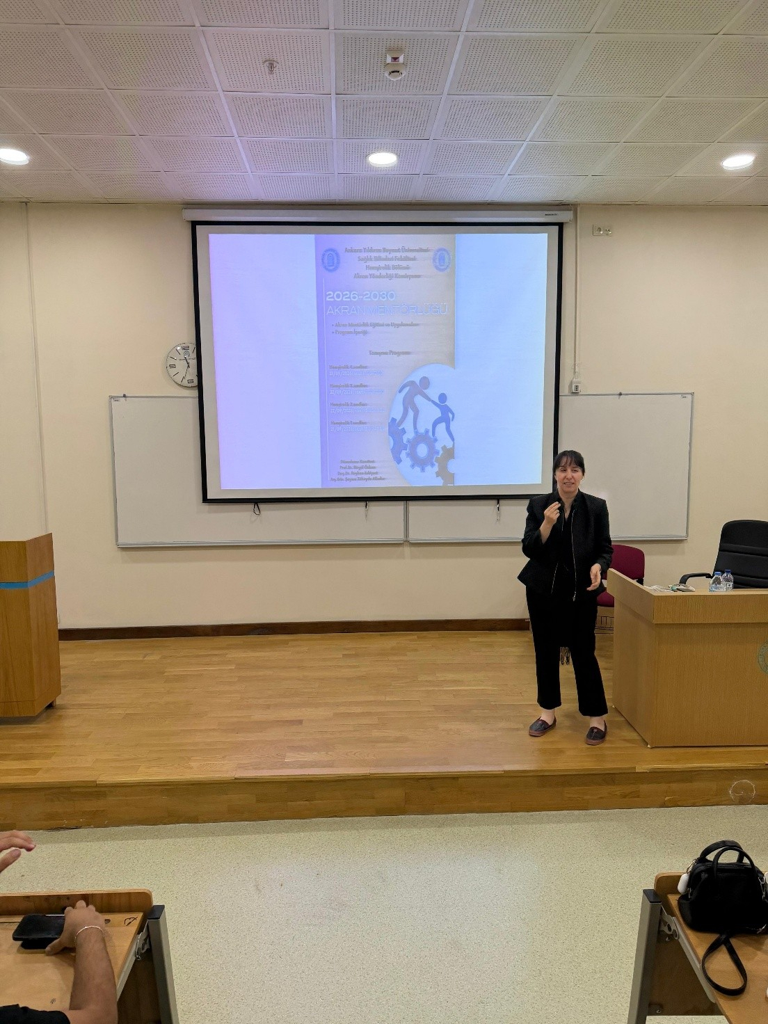 Associate Professor Reyhan Eskiyurt introducing the Mentor–Mentee Program poster to fourth-year students.