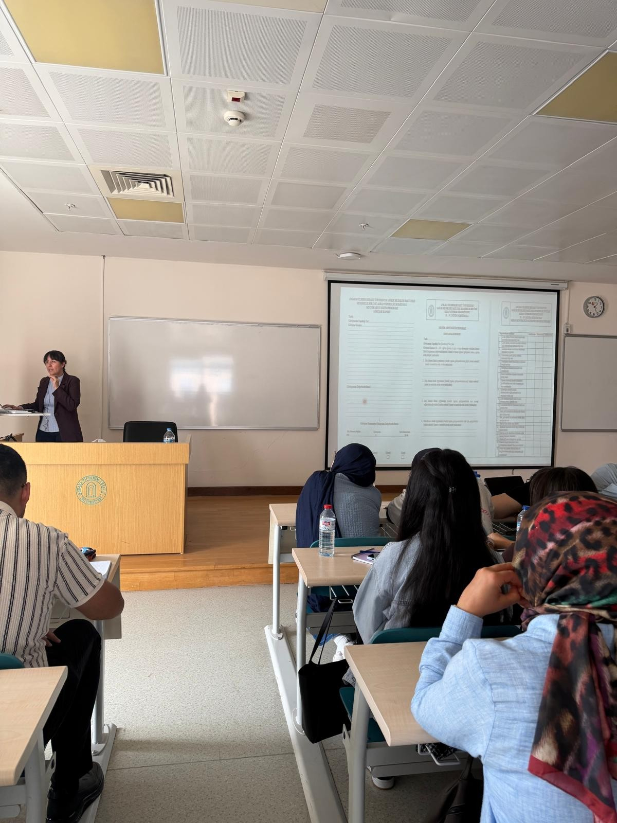 Associate Professor Reyhan Eskiyurt introducing the forms to be used throughout the Mentor–Mentee Program and explaining how to complete them to second-year students.